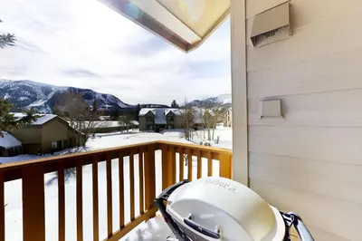 a helmet on a balcony with a view of a snow covered mountain at Snowcreek 264 in Mammoth Lakes
