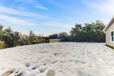 a snow covered roof of a house at Zerenity Lookout East in Oakhurst