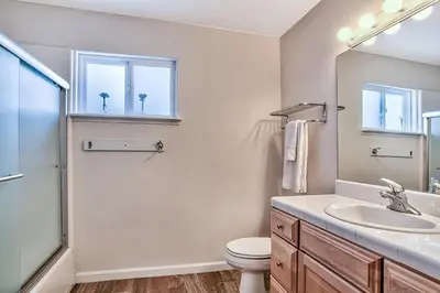 a bathroom with a sink and a toilet and a mirror at 1759 Venice Drive home in Tahoe Keys
