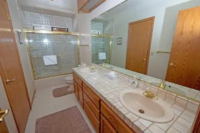 a bathroom with a sink and a toilet and a mirror at 2293 Marshall Trail home in South Lake Tahoe
