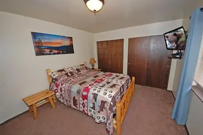 a bedroom with a bed and a tv in it at 1987 Cherokee St, home in South Lake Tahoe