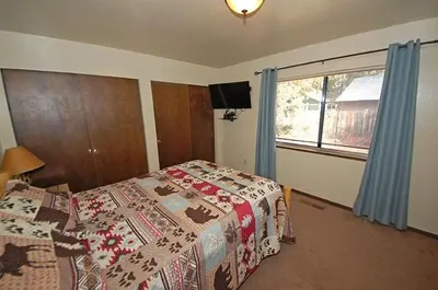 a bedroom with a bed and a window at 1987 Cherokee St, home in South Lake Tahoe