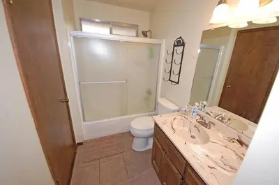 a bathroom with a sink and a toilet and a mirror at 1987 Cherokee St, home in South Lake Tahoe