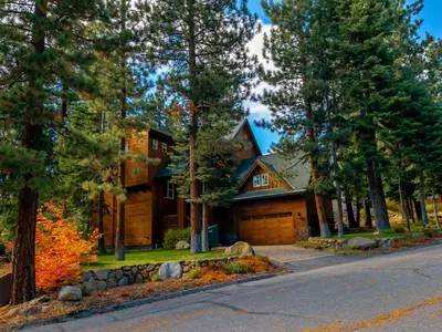 a house in the woods with a driveway at Canterbury Lodge in Kings Beach