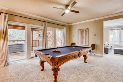 a pool table in a living room with a ceiling at Canterbury Lodge in Kings Beach