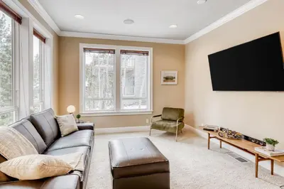 a living room with a couch and a flat screen tv at Canterbury Lodge in Kings Beach