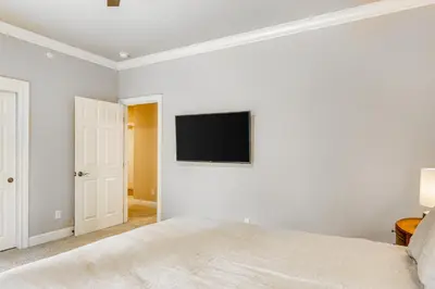 a bedroom with a bed and a tv on the wall at Canterbury Lodge in Kings Beach