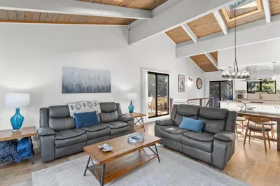 a living room with two couches and a table at Fun & Air Conditioned Lake Tahoe 3 BR/2.5 BA Home in Incline Village