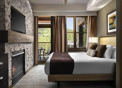 a hotel room with a bed and a fireplace at Hyatt Vacation Club at Northstar Lodge in Truckee