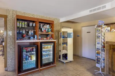 a room with a refrigerator and shelves in a store at Best Western Frontier Motel in Lone Pine