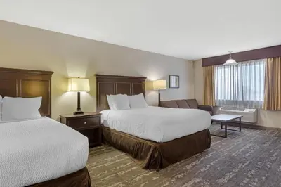 a hotel room with two beds and a couch at Best Western Frontier Motel in Lone Pine