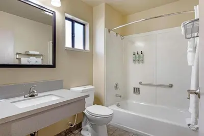 a bathroom with a sink and a toilet and a bath tub at Best Western Frontier Motel in Lone Pine