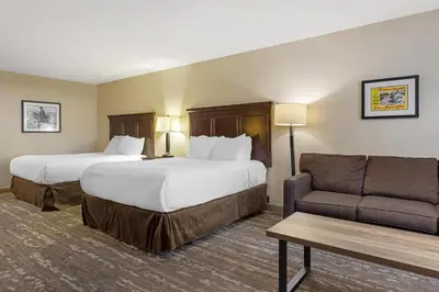 a hotel room with two beds and a couch at Best Western Frontier Motel in Lone Pine