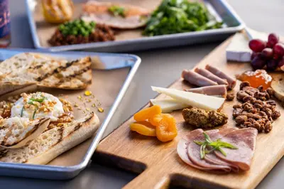 a table with a bunch of different types of food at Under Canvas Yosemite in Groveland