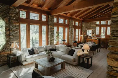 a living room with a couch and a table at Luxury Nature Getaway Stone House by Casa Oso in Mariposa