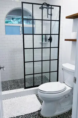 a bathroom with a white toilet and a shower at Serene Modern Family Getaway Near Midtown Downtown and Folsom Lake in Elk Grove