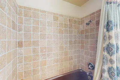 a bathroom with a shower with a tub at Yard and Patio Quiet and Well-Stocked Riverside Home in Three Rivers