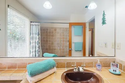 a bathroom with a sink and a mirror at Yard and Patio Quiet and Well-Stocked Riverside Home in Three Rivers