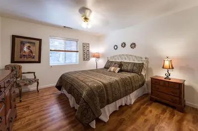 a bedroom with a bed and a dresser and a window at Upper Cascades in Yosemite West