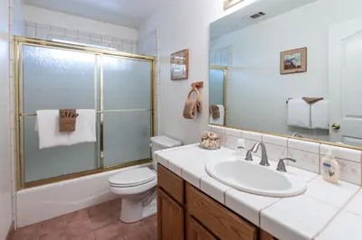 a bathroom with a sink and a toilet and a mirror at Upper Cascades in Yosemite West