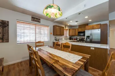 a kitchen with a wooden table and a dining room at Upper Cascades in Yosemite West