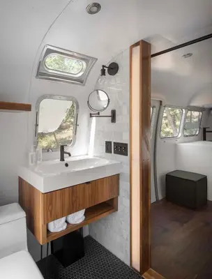 a bathroom in an rv with a sink and a mirror at AutoCamp Sequoia in Three Rivers