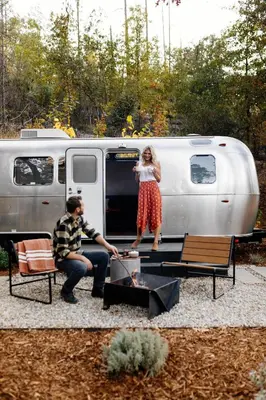 a man and a woman standing in front of a rv at AutoCamp Sequoia in Three Rivers