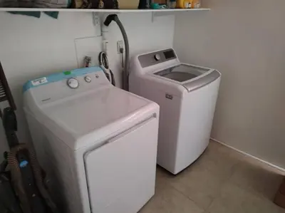 a white washer and dryer in a small room at Campground at Sequoia Mountain Farms - Bring Your Own Tent or RV - No Bedrooms or Beds Provided in Miramonte