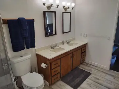 a bathroom with a toilet and a sink and a mirror at Campground at Sequoia Mountain Farms - Bring Your Own Tent or RV - No Bedrooms or Beds Provided in Miramonte