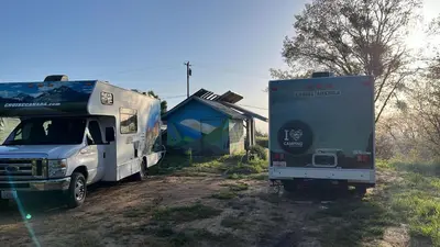 a camper and a truck parked next to a house at Campground at Sequoia Mountain Farms - Bring Your Own Tent or RV - No Bedrooms or Beds Provided in Miramonte