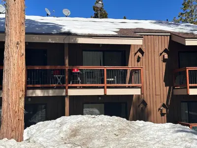a house with a deck in the snow at Yosemite Condominium Loft unit -B202 in Yosemite West