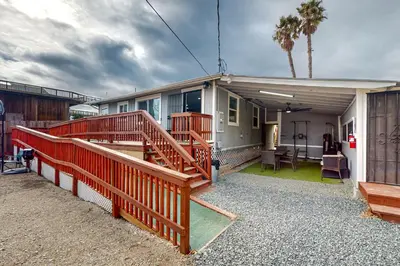 a home with a large deck with a house at Riverside Retreat in Bethel Island Fish and Boat! in Bethel Island