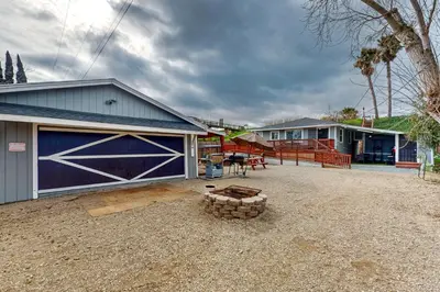 a backyard with a garage and a fire pit at Riverside Retreat in Bethel Island Fish and Boat! in Bethel Island