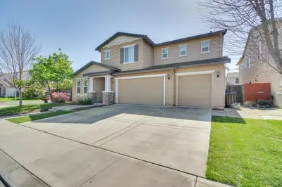 a house with a driveway and a garage at 4 Mi to Dtwn Merced Spacious Home with Yard! in Merced