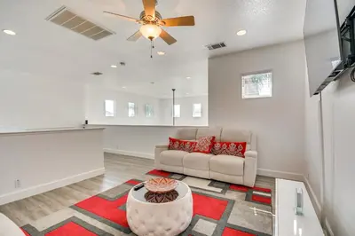 a living room with a couch and a ceiling fan at 4 Mi to Dtwn Merced Spacious Home with Yard! in Merced
