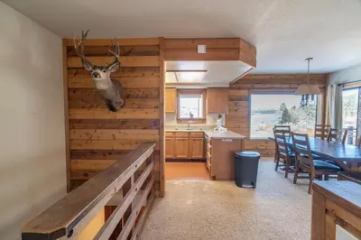 a kitchen and dining room with a deer head hanging on the wall at Rr-edgewater10 in June Lake