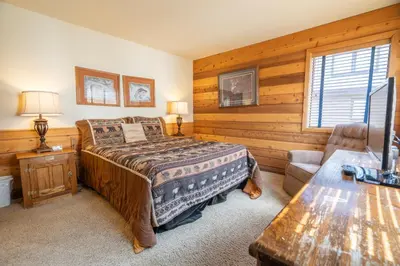 a bedroom with a bed and a couch and a table at Rr-edgewater10 in June Lake