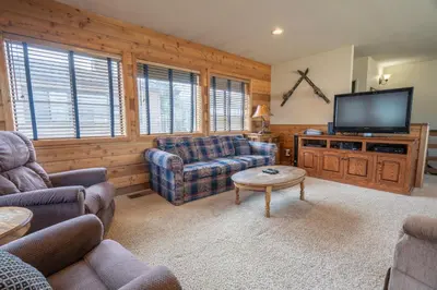 a living room with couches and a flat screen tv at Rr-edgewater10 in June Lake