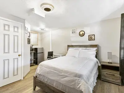 a bedroom with a large white bed and a desk at Charming Retro Property 6 in Sparks