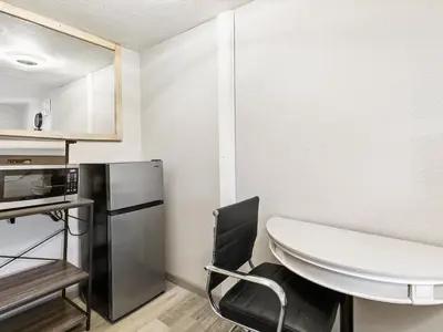 a small kitchen with a table and a microwave at Charming Retro Property 6 in Sparks
