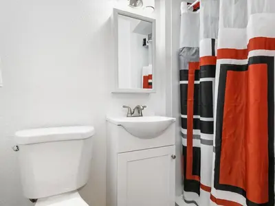 a bathroom with a sink and a toilet and a mirror at Charming Retro Property #3! in Sparks