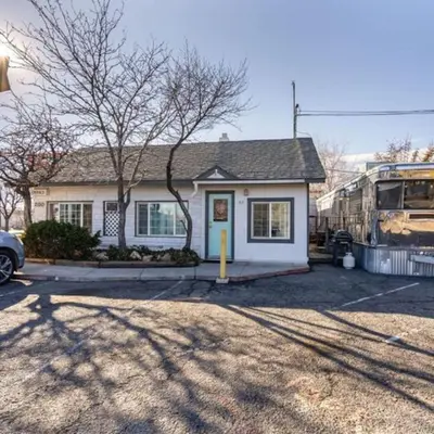 a bus is parked in front of a house at Charming Retro Property #3! in Sparks