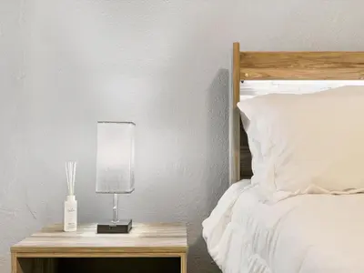 a bed with a nightstand with a lamp on it at Charming Retro Property #3! in Sparks