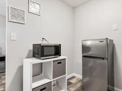 a kitchen with a refrigerator and a microwave at Charming Retro Property 8 in Sparks