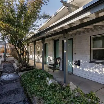 a porch of a house with a chair on it at Charming Retro Property 8 in Sparks