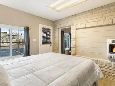 a bedroom with a large bed and a fireplace at Charming Retro Property 22 in Sparks