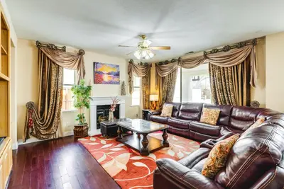 a living room with a leather couch and a table at Outdoor Oasis and Hot Tub! Spacious Clovis Home in Clovis