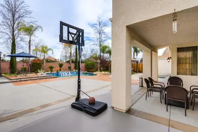 a basketball hoop in the middle of a patio at Outdoor Oasis and Hot Tub! Spacious Clovis Home in Clovis