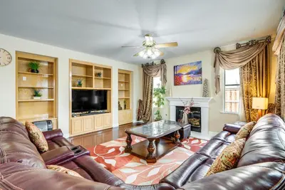 a living room with leather couches and a coffee table at Outdoor Oasis and Hot Tub! Spacious Clovis Home in Clovis