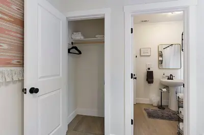 a bathroom with a white door and a sink at East Sac Getaway, Walking Distance to Hospitals in Sacramento